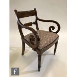 A late Regency period mahogany scroll arm carver chair, with bar back above the tapestry upholstered