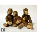 Three British monkeys, two in brown mohair, one in cinnamon, each with felt faces, hands and feet,