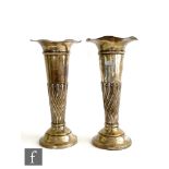 A matched pair of hallmarked silver trumpet vases each with part wrythen fluted decoration below