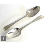 A pair of George III hallmarked silver table spoons with beaded borders, engraved initials to
