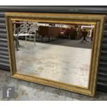 A 20th century rectangular gilt framed bevelled edge wall mirror, 120cm x 95cm.