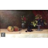 J. M. WHITE (EARLY 20TH CENTURY) - A still life with fruit and a tazza on a table top, oil on