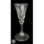 An 18th Century wine glass circa 1750, the pointed round funnel bowl above a balustroid stem with