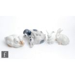 Three Royal Copenhagen model animals comprising two playful puppies, model 453, two huddled ducks,