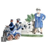 A later 20th Century Rye Pottery model of a farmer stood in a blue smock beside his Sussex pig,