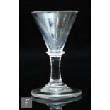 A late 18th Century dram glass circa 1780, the conical bowl above a plain stem with bladed