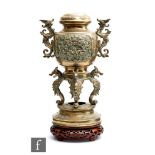 A Chinese late Qing Dynasty (1644-1912) censer, the lower circular plinth raised on four scroll