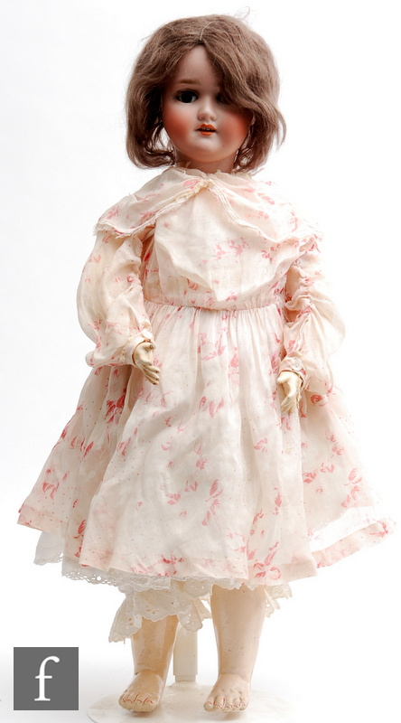 An early 20th Century Schoenau and Hoffmeister bisque socket head doll, head mould 1909, with