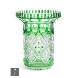 A 20th Century crystal glass vase of footed cylindrical form with a collar rim, cased in emerald