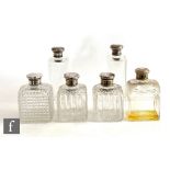 Two pairs of hallmarked silver and clear glass scent bottles each with engine turned decoration to
