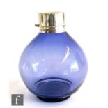 A hallmarked silver and glass globular scent bottle, the purple glass body below plain silver collar