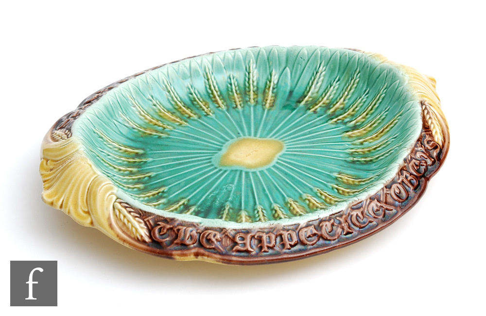 A late 19th Century majolica shaped bread plate with the motto 'Where reason rules the appetite