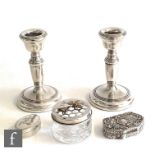 A pair of hallmarked silver piano candlesticks each with reeded borders, height 10cm, Birmingham