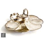 A Victorian hallmarked silver desk stand, the fluted stylised shell base supporting an inkwell in