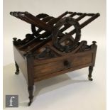 A 19th Century rosewood three-division Canterbury, with carved laurel leaf garlands above an
