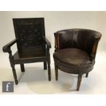 An early 20th Century mahogany tub shaped easy chair with turned arms, on fluted legs, upholstered