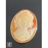A 9ct hallmarked oval cameo brooch, head and shoulder profile of a young lady, all within a rope