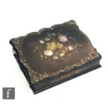 A Victorian papier mache writing slope inlaid with mother of pearl flowers within a shaped border,