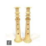 A pair of bone candlesticks, each modelled as a lighthouse with simulated brick work