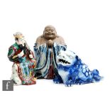 A collection of Chinese porcelain figures, to include a blue and white glazed shishi figure,