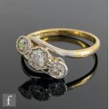 A mid 20th Century 18ct diamond three stone ring, illusion set stones to a slight twist, centre