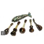 A mother of pearl articulated fish and five miniature tortoiseshell mandolins and guitars. (6)