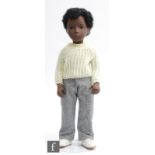 A Trendon Sasha 318 Caleb doll, wearing original yellow sweater, cotton trousers, pants, socks and