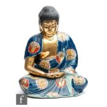 A Chinese Republic Period (1912-1949) porcelain figure of Shakyamuni Buddha, eyes downcast, modelled