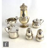 Six hallmarked silver items to include two mustard pots, a salt and a pepper, each modelled as an