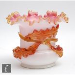 A large late 19th Century posy bowl cased in opal over pink with an applied amber trim to the rim