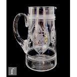 A late Victorian clear glass jug of cylindrical form, decorated with alternating engraved and etched