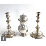 A pair of hallmarked silver candlesticks, circular stepped bases below knopped columns and