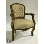 A 20th Century gilt wood fauteuil open armchair, with foliate crest to the top rail, re-