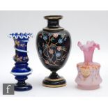 A late 19th Century footed ovoid vase with collar neck, hand enamelled in the aesthetic taste with a
