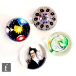 A group of four assorted glass paperweights, to include a portrait of a gentleman, a green and clear
