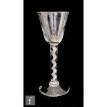 An 18th Century drinking glass circa 1760, the round funnel bowl above an air twist stem with a