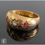 An early 20th Century 18ct hallmarked three stone ruby and diamond ring gypsy set stones to a