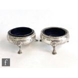 A pair of George III hallmarked silver circular open salts each raised on three stepped feet, London