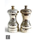 A hallmarked silver pepper and salt mill, each of plain baluster form, pepper with gilt finial,