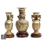 A collection of Chinese gilt metal vases, each of bottle form, one all cast with wrythen dragons and