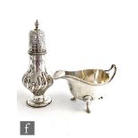 A Victorian hallmarked silver castor, height 14cm, with a hallmarked silver sauce boat, total weight