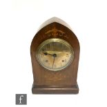 An Edwardian marquetry inlaid mahogany mantle clock of lancet shaped form, eight day spring driven