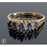 A 14ct sapphire and diamond ring, five marquise sapphires each spaced by a pair of diamonds, all