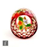 A 20th Century paperweight, internally decorated with lampwork yellow and white flowers, the outside