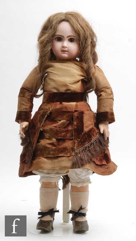A late 19th Century Jumeau Bebe bisque socket head doll, with fixed brown paperweight eyes,