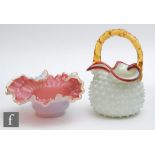 A late 19th Century posy basket in opal glass with a dimple body and applied ruby triform rim with