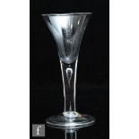 An 18th Century drinking glass circa 1740, the drawn trumpet bowl above a plain teared stem and