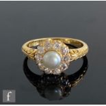 An early 20th Century 18ct diamond and split pearl cluster, central pearl within a border of ten old