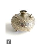 An early 20th Century Dutch silver circular table lighter with embossed decoration, three tapers