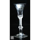 An 18th Century wine glass circa 1740, the bell bowl with solid base above a composite stem with a
